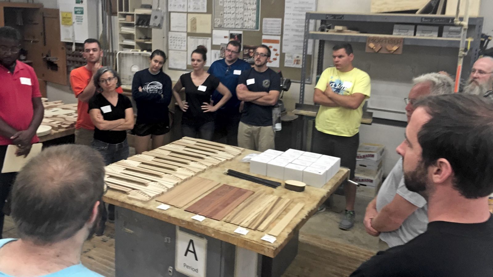 Pennsbury High School teachers receive directions as they prepare to build electric guitars