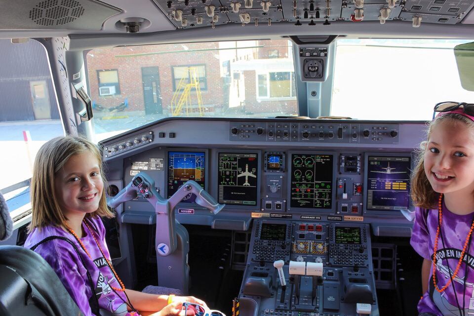 Girls sit in the cockpit a jet at the Purdue Airport during the 2017 Girls in Aviation Day
