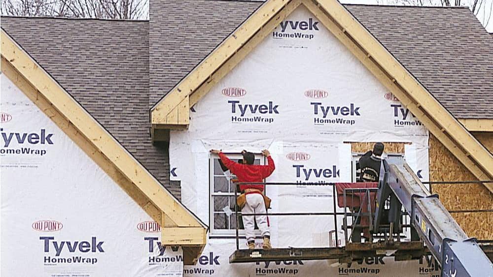A version of Tyvek, the synthetic, waterproof material shown here on a home under construction, can be made into isolation gowns.