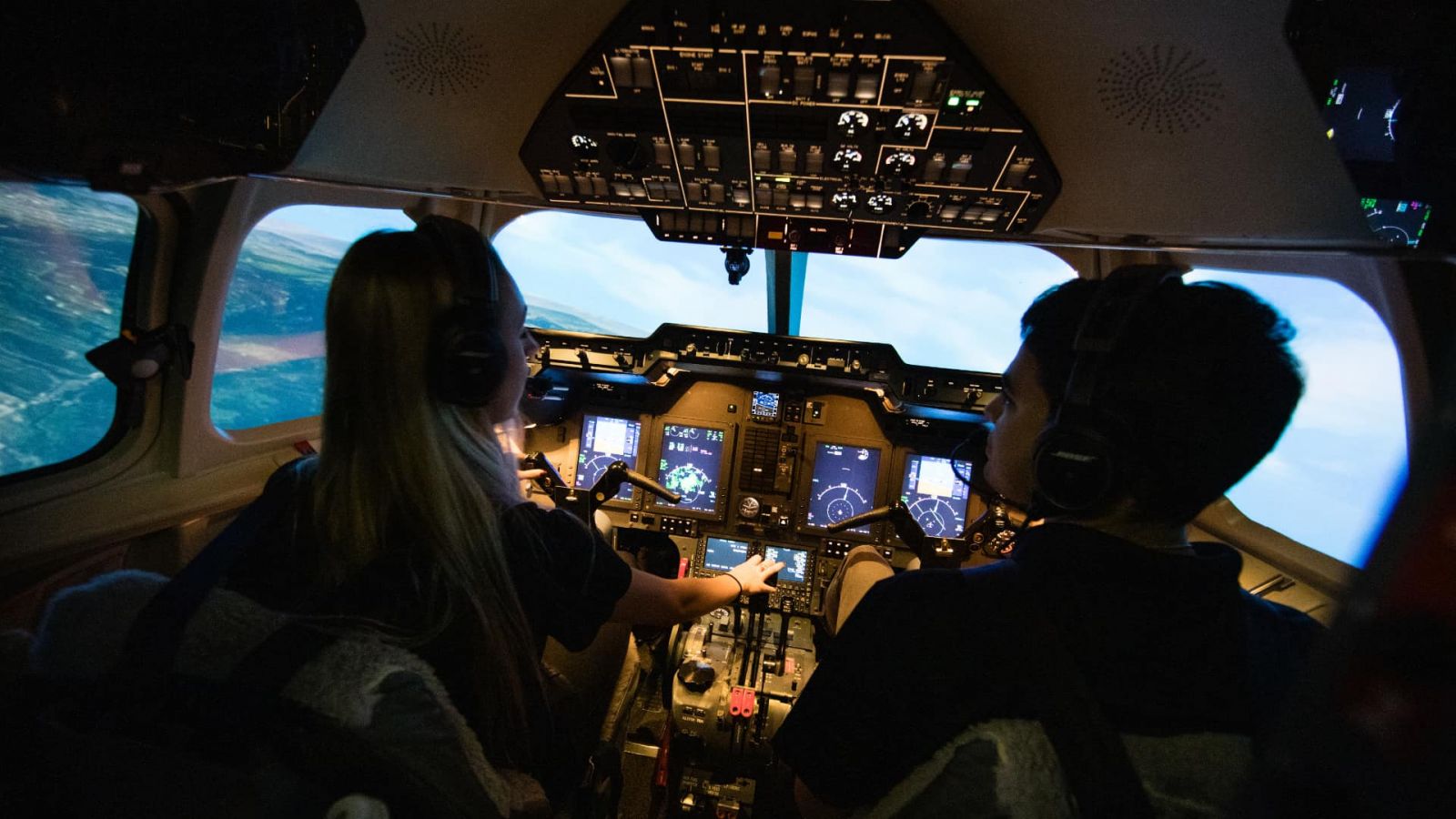 A student pilot and instructor use Purdue Polytechnic's Hawker 900XP flight simulator (Purdue University photo/Brian Powell)