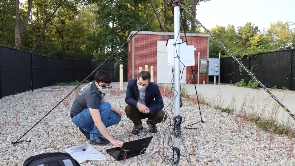 Luis Maldonado and Jason Ostanek check weather sensor data at a cellular transmitter adjacent to ventilation shafts connected to Citizens Energy Group’s DigIndy Tunnel System in Indianapolis, Indiana. (Purdue University photo/John O’Malley)