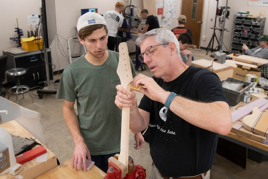 Mark French, professor of mechanical engineering technology, with a student in the popular "guitar lab" course (Purdue University photo/John Underwood)