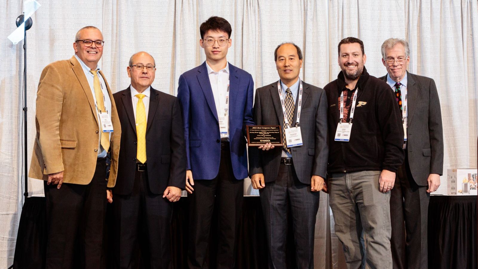 Starting from the center and proceeding right, Boxiang Zhang, Xiaoming Wang and Corey Vian accept the award for Best Congress Paper alongside representatives from NADCA. (Photo provided)