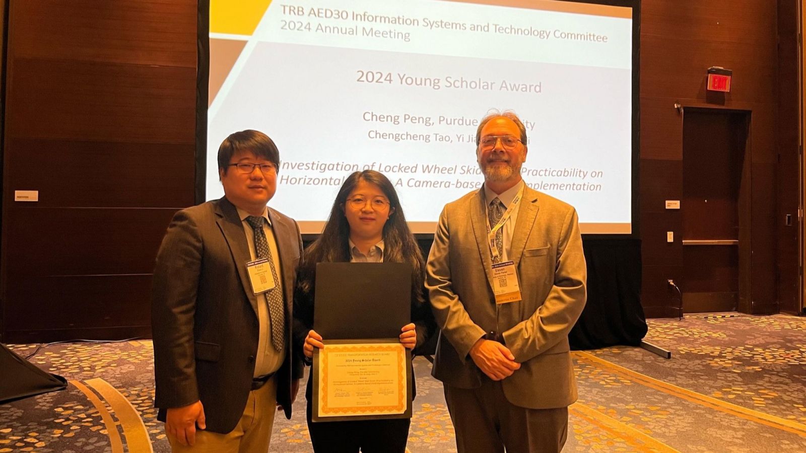 Cheng Peng (center) receives TRB's Young Scholar Award at their 2024 Annual Meeting. (Photo provided)